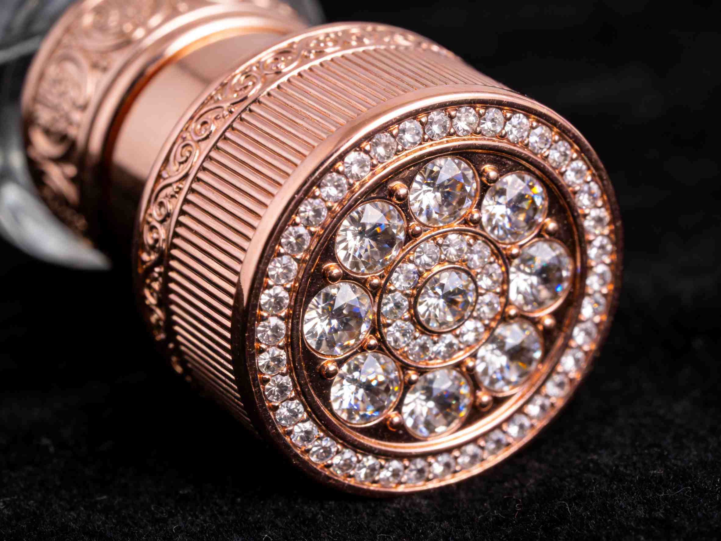 Cap features Swarovski crystals and rose gold plating