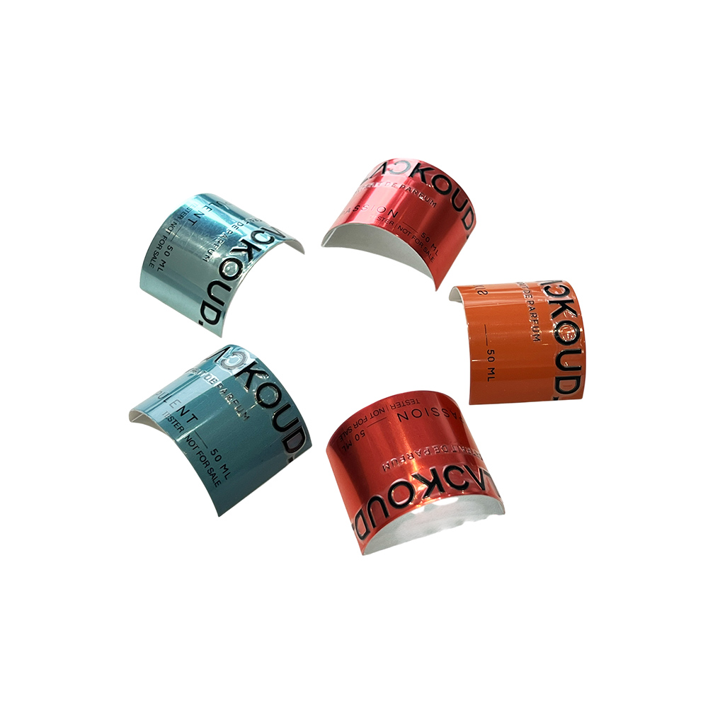 Circular arrangement of pre-curved aluminum perfume labels in metallic blue, red, and orange
